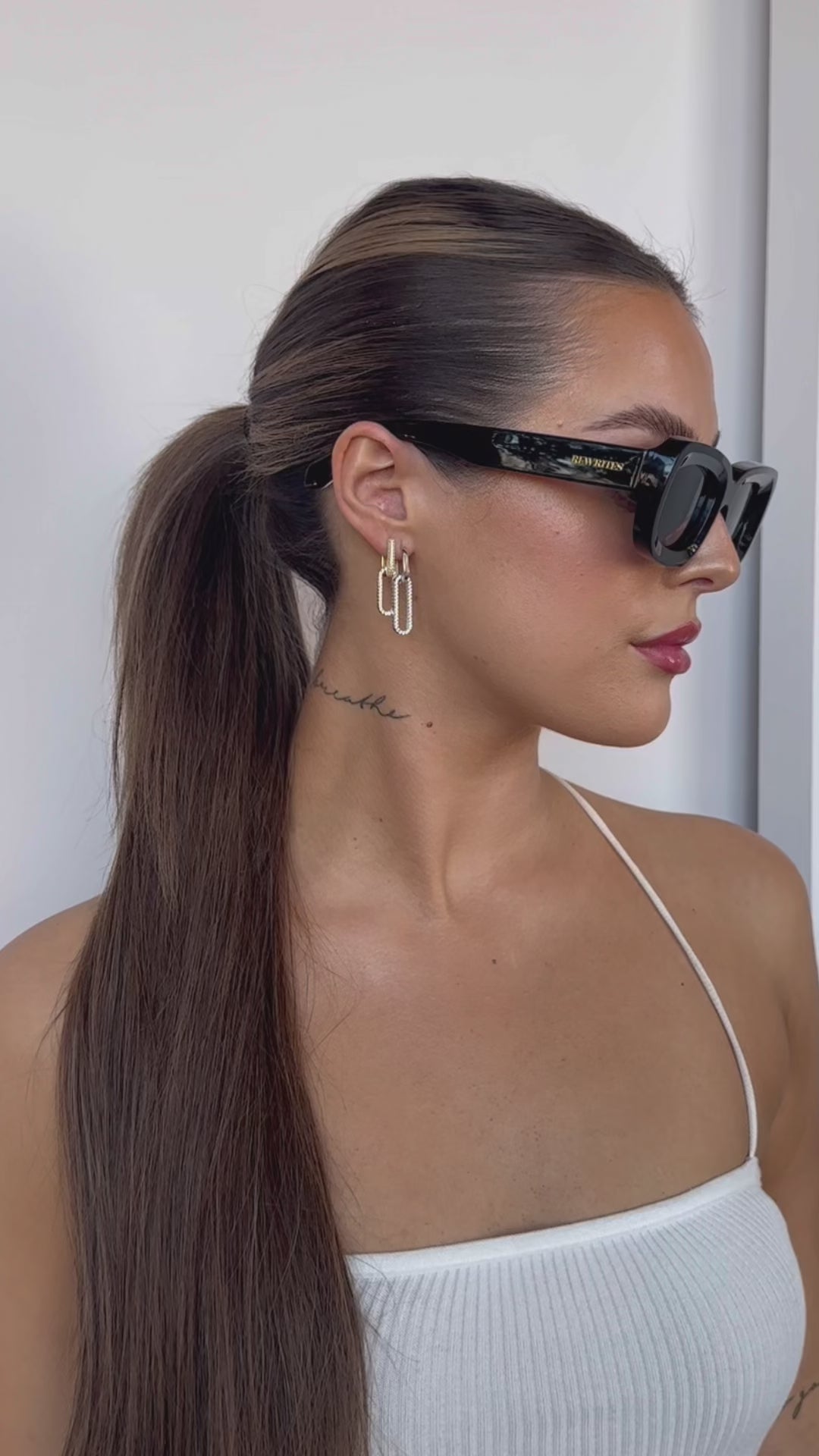 Three models, all with oval face shapes, are showcased wearing our unisex Unfazed sunglasses. These sunglasses feature a sleek black rectangular frame and grey see-through lenses. They offer TAC polarized lenses with a scratch-resistant coating, providing full UV protection up to 500 nanometers. Designed for universal fit and extreme comfort, they ensure a stylish and comfortable experience for all wearers.